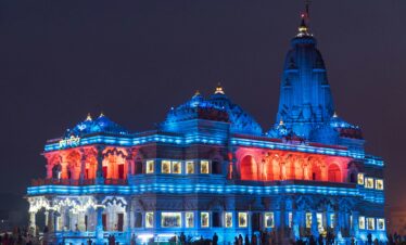 Prem Mandir Vrindavan illuminated with colourful lights at night